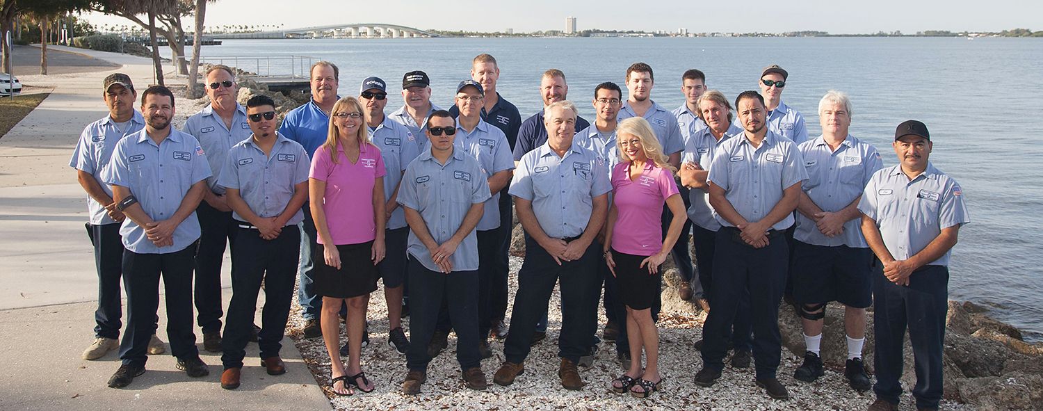 The Professional Plumbing & Design team with the Ringling Causeway and Sarasota Bay in the background.