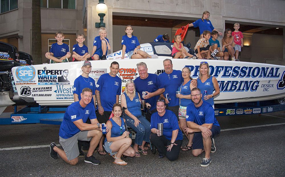 The extended Wittman family in front of the Professional Plumbing & Design Power Boat at the 2019 Grand Prix Bock Party.