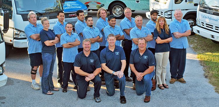 sarasota plumbing team in front of trucks